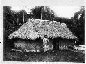 Woman standing outside of Tongan house
