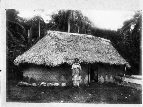 Woman standing outside of Tongan house