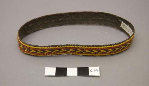 Narrow basketry armband - dark brown with red and yellow design