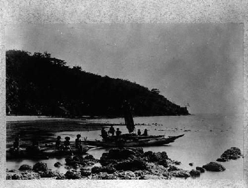 Group at shore with two boats