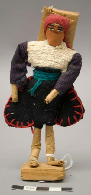 Doll, man with jodhpur-style pants, affixed to stand