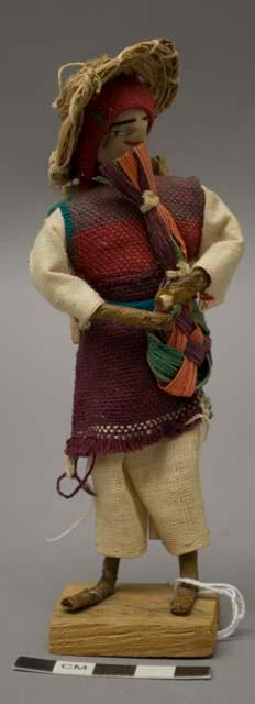 Doll, man with wood bundles, straw hat and fan, affixed to stand