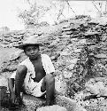 Workman sitting in front of stairway repair, Structure Q-82