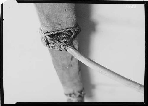 Close-up of outrigger lashing on model canoe