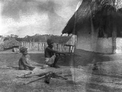 Diviner and young boy, preparing hot iron