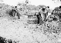 Men filling in trench 9 to preserve columns in situ