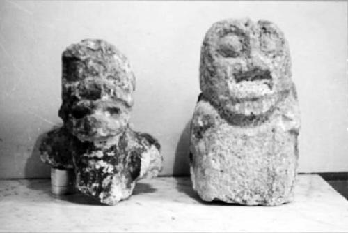 Two limestone human figures