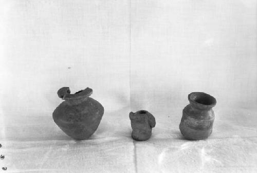 Pottery artifacts from excavation, miniature pot, olla, and spouted vessel