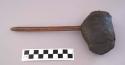 Small axe or hammer of rock covered with hide, on a thin wooden handle