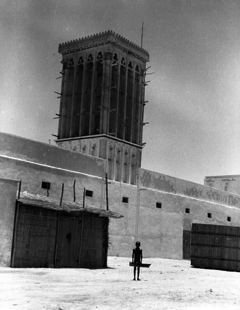 Wind tower over petroleum development house