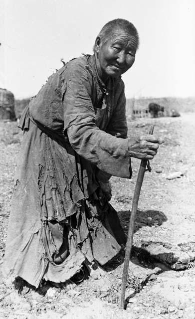 Old woman leaning on cane