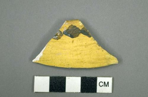 Ceramic rim sherd, black on yellow design