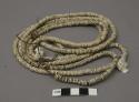 Ostrich shell necklace, likely on sinew cord