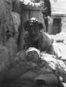 Severly injured man  with bandaged head, lying down