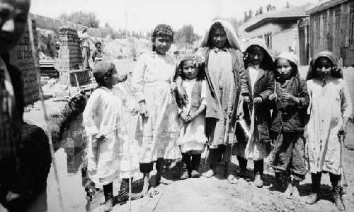 Portrait of five young children and two older girls