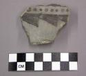 Ceramic, body sherd with remant of lug, black designs on interior