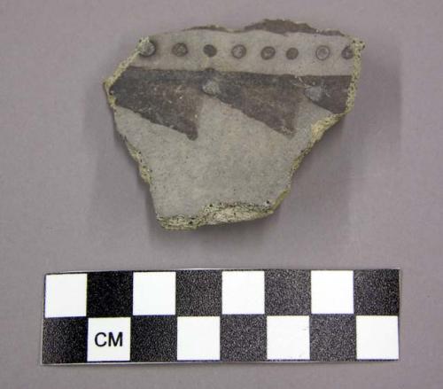 Ceramic, body sherd with remant of lug, black designs on interior