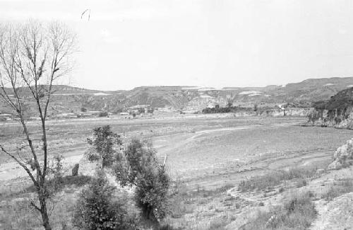 Landscape of hillsides. Trees in foreground