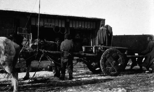 Four men around horse and wagon