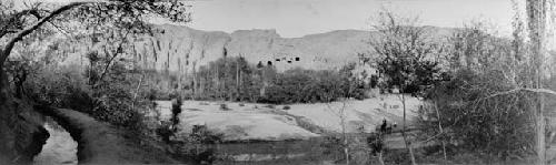 Wide panoramic photograph shot of fields, trees, river