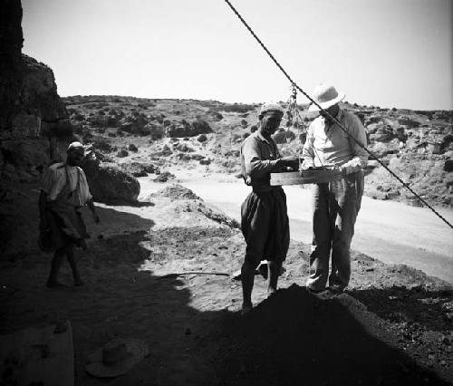 Excavation of Ashakar cave sites, sifting silt