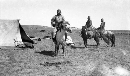 Three Mongols mounted on ponies