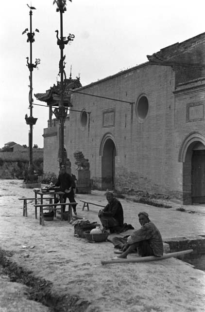 Shansi, September 1935, temple and foodsellers outside gate at Anyi