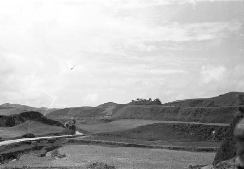 Road through hills with cultivated fields