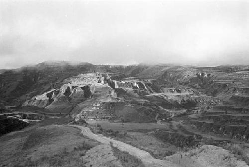 Landscape with high hills and plateaus, road in front