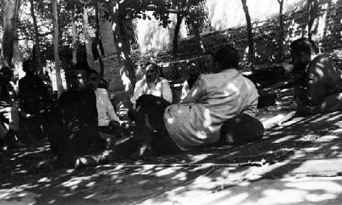 Grape Valley picnic, men lounging under trellised awning