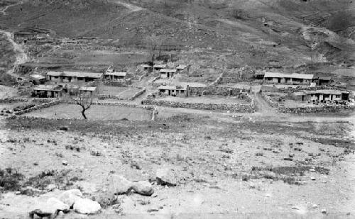 View from a distance of several inns at the base of a large hill