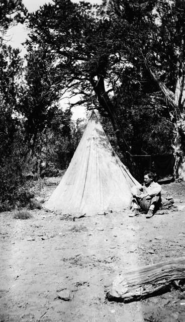 Dr. Kidder beside tent