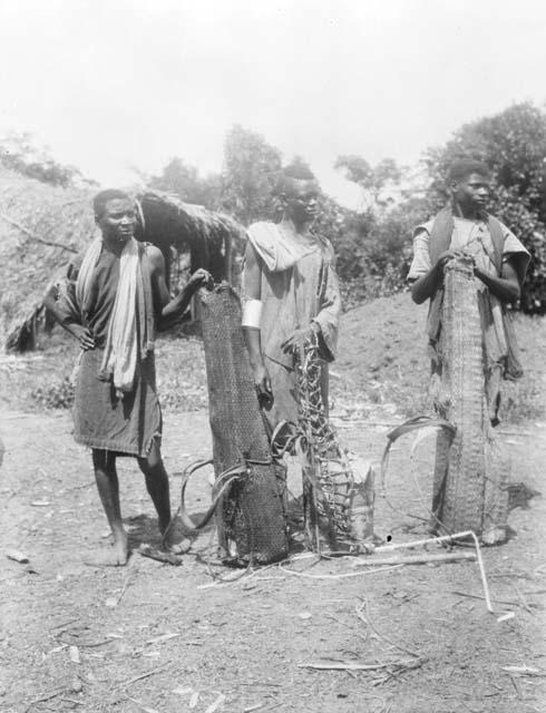 Three women carrying large loads