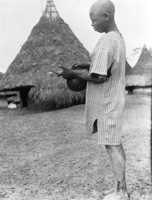 Man with harp-like instrument