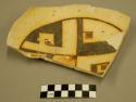 Fragments of black-on-yellow pottery bowl
