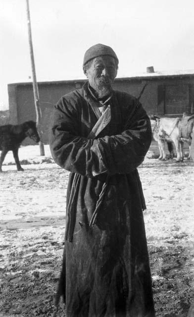 Portrait of an old man standing outside