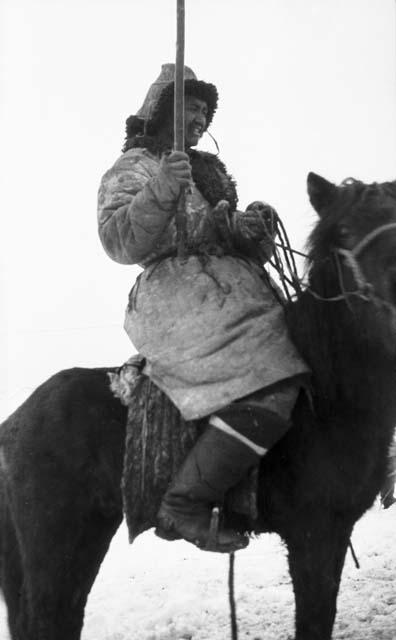 Close-up of Kazak on horse, holding lasso