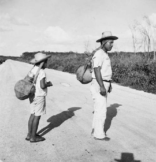 Olegario (father) & Candelario (son) Camara carrying Tepakan cantaros by Mecapal