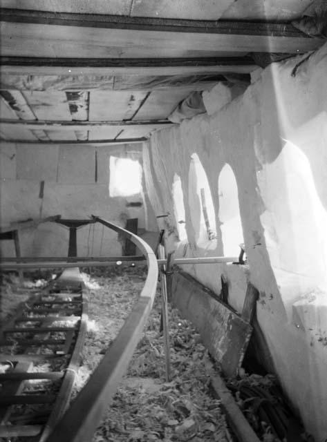 Interior of Eskimo boat shop, showing omiak frame under construction