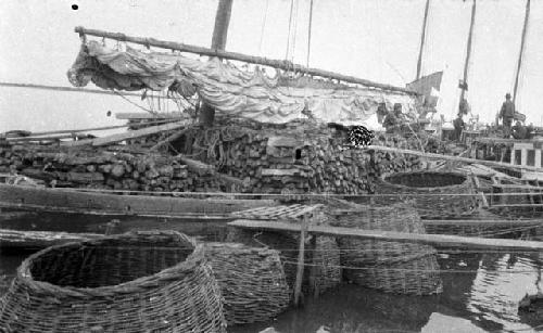 Fish cages on junk, men in background