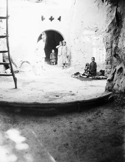 Old man and children in Grape Valley courtyard