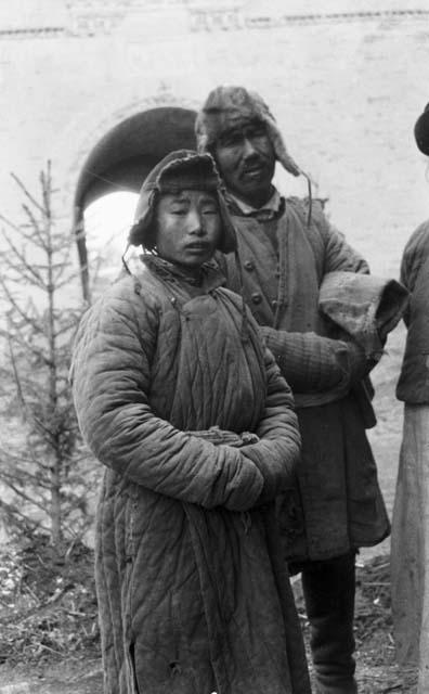 Kazak boy and man, city gate in background