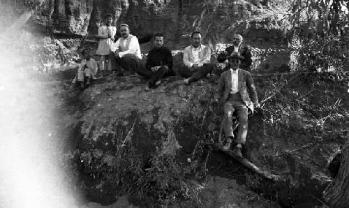 Grape Valley picnic, men and boys sitting on the edge of a ravine