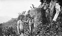 Men standing next to stone slabs