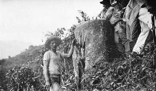 Men standing next to stone slabs