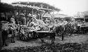 Horse carts backed-up to open covered structure