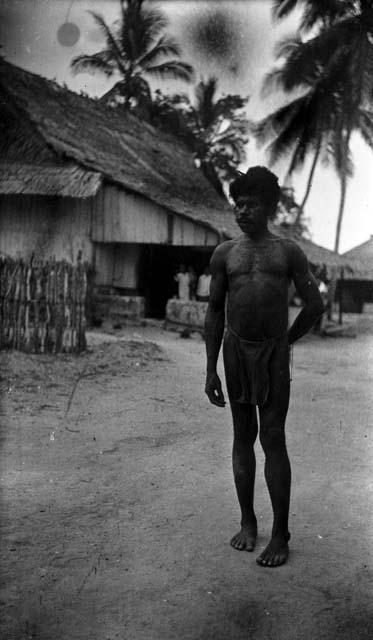 Man standing on path in front of house