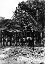 Laborers in front of house frame