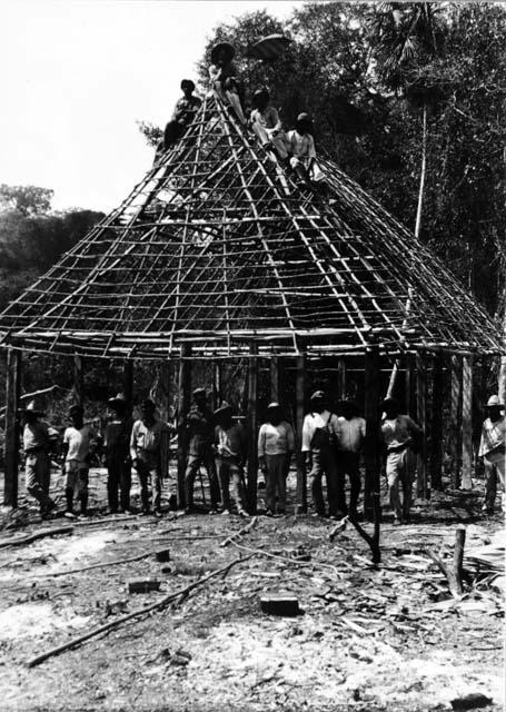 Laborers in front of house frame