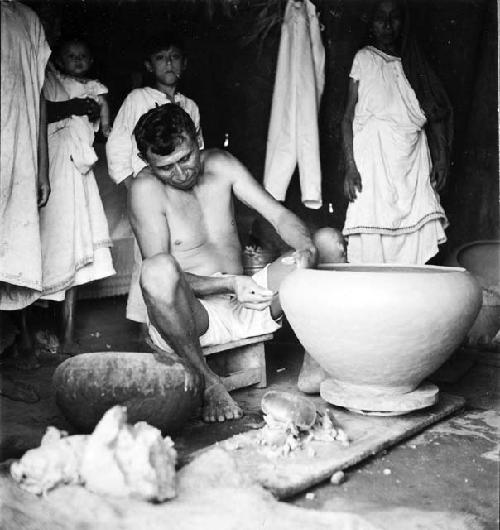 Modern pottery making - resting on a kabal which in turned by the hands or feet